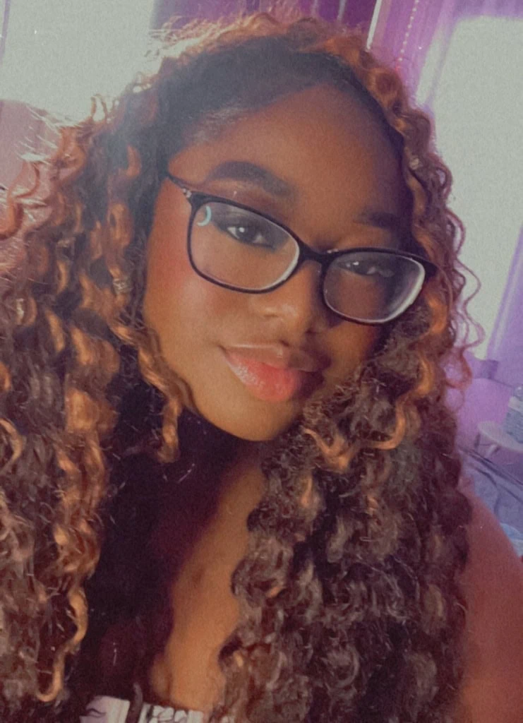 A smiling woman wearing glasses